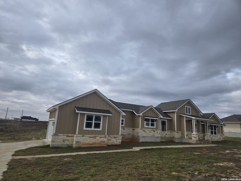 Front exterior of a new home in , La Vernia, TX, highlighting curb appeal (Image 1). Front exterior of a new home in , La Vernia, TX, highlighting curb appeal (Image 1).