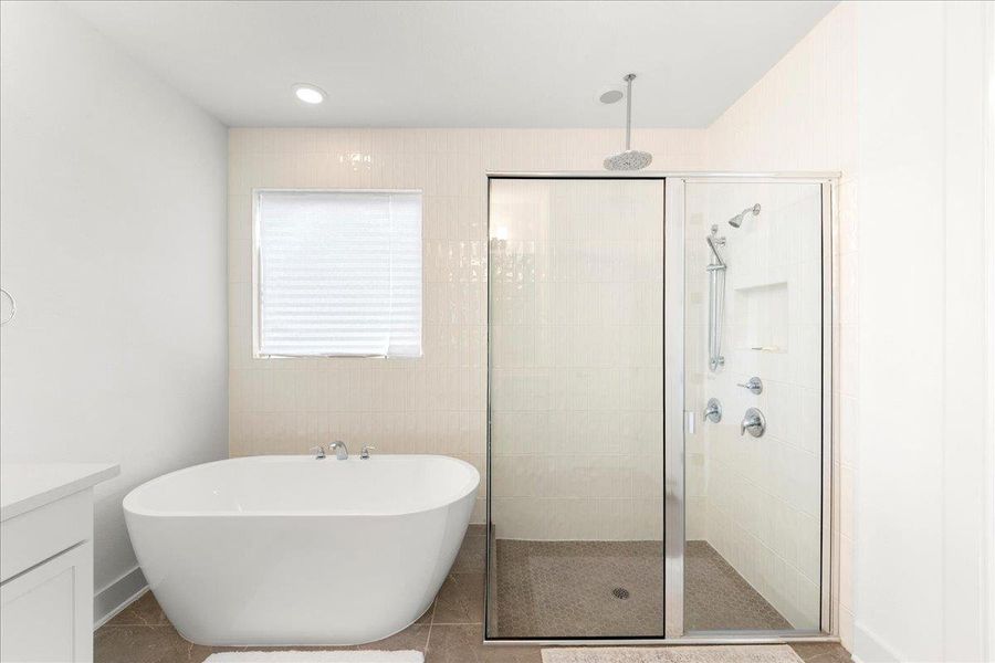 Bathroom with vanity, a freestanding bath, a shower stall, recessed lighting, and tile patterned floors Bathroom with vanity, a freestanding bath, a shower stall, recessed lighting, and tile patterned floors