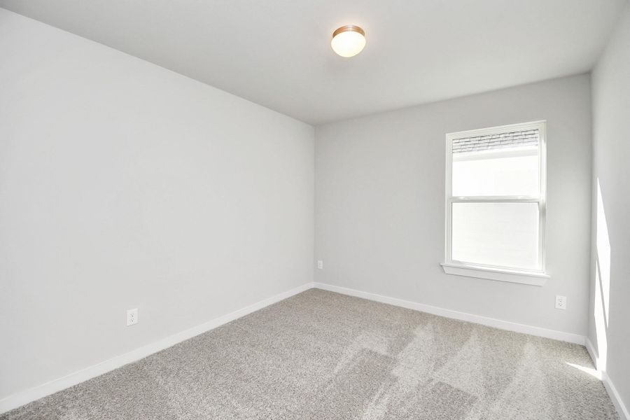 Discover another perspective of the secondary bedroom! Sample photo of completed home with similar floor plan. Actual colors and selections may vary.