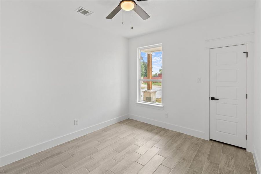 Unfurnished room with light hardwood / wood-style flooring and ceiling fan