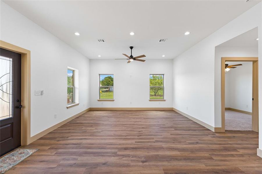 Foyer entrance featuring recessed lighting, healthy amount of natural light, dark wood-style floors, and a ceiling fan