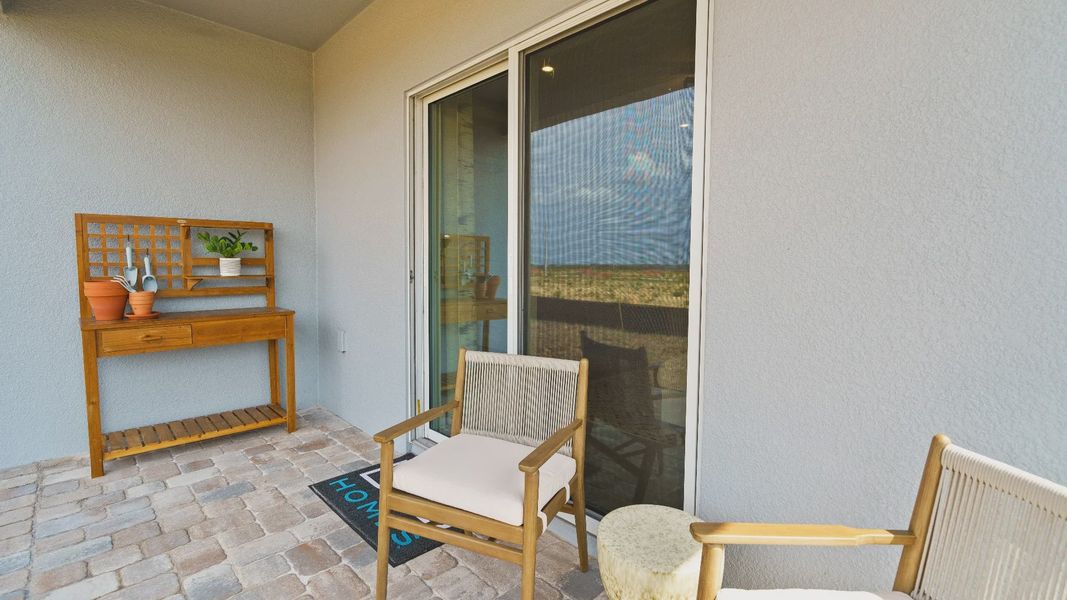 Atlantic Plan Single Story Home by DRB Homes, Rear exterior covered lanai staged with furniture. Atlantic Plan Single Story Home by DRB Homes, Rear exterior covered lanai staged with furniture.