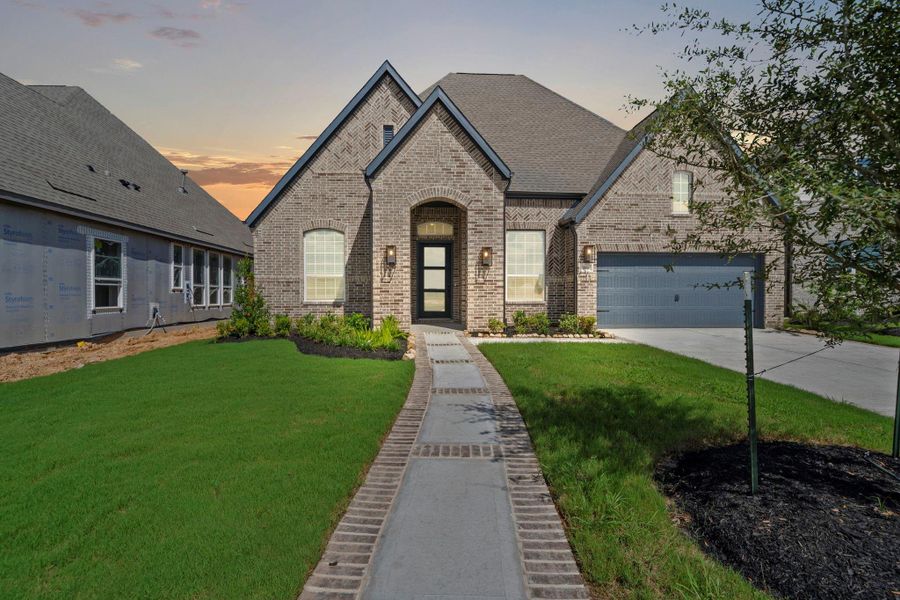 Front exterior of a new home in Elyson 60's, Katy, TX, highlighting curb appeal (Image 2). Front exterior of a new home in Elyson 60's, Katy, TX, highlighting curb appeal (Image 2).