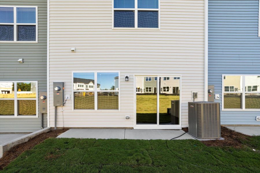 Exterior details and patio area of a home in West Main Townhomes, Sanford (Image 3).