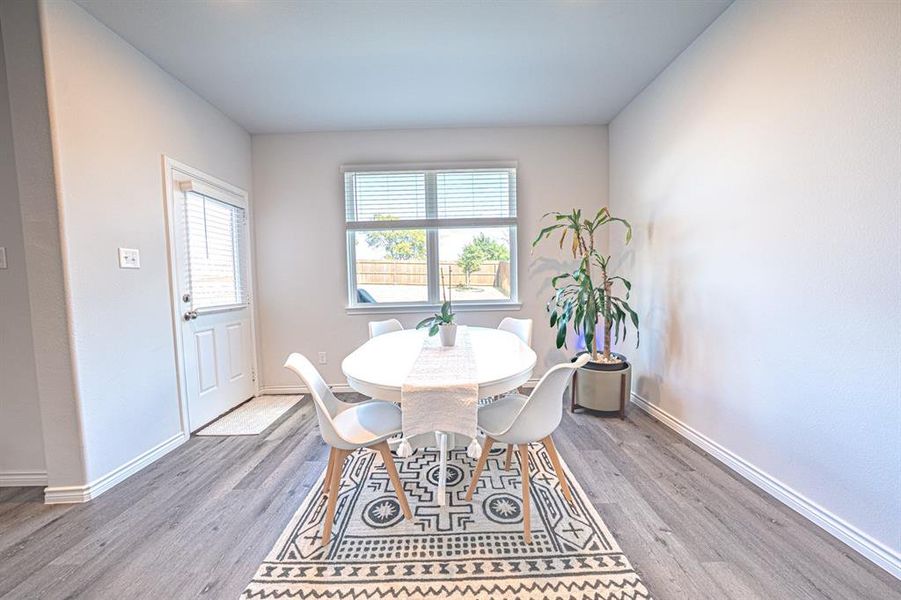 Dining space featuring wood finished floors and baseboards