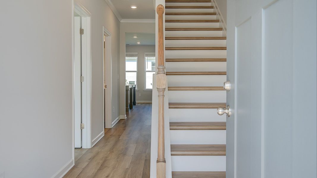 Ridgewood welcoming entry into open foyer and staircase featuring LVP flooring at Bowers Farm in McDonough, GA.