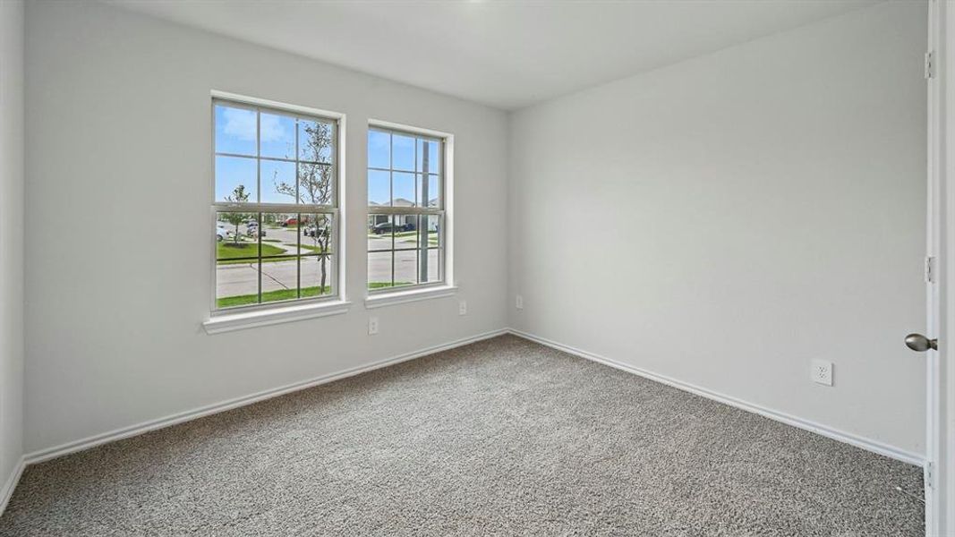 Spare room with carpet and baseboards