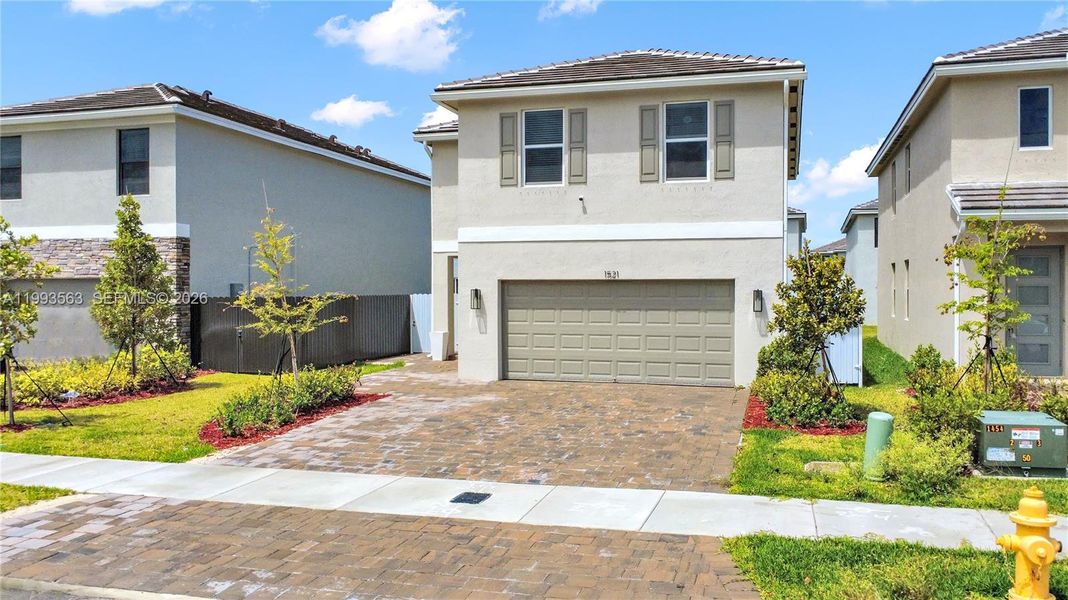 Front exterior of a new home in Messina Place, Homestead, FL, highlighting curb appeal (Image 27). Front exterior of a new home in Messina Place, Homestead, FL, highlighting curb appeal (Image 27).