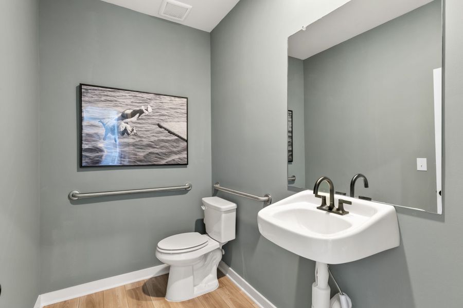A bathroom with a picture on the wall. A bathroom with a picture on the wall.