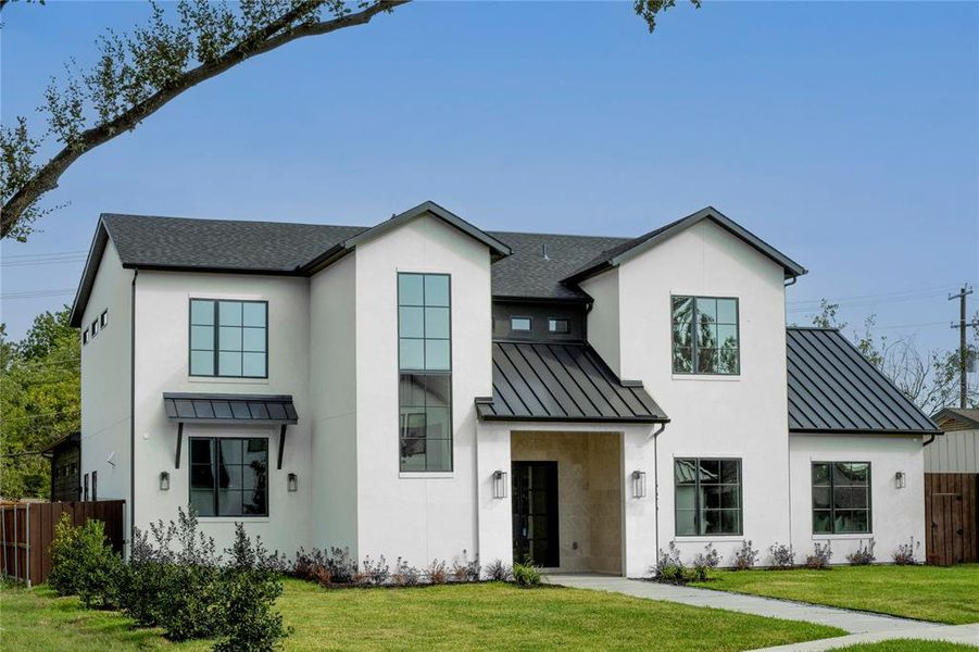 Modern inspired farmhouse featuring a front yard