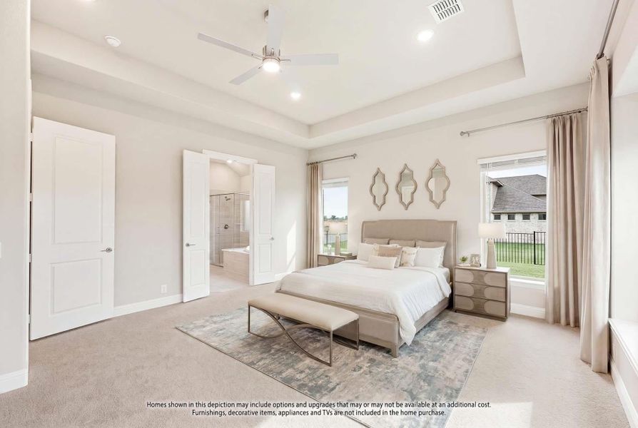 Master bedroom with tray ceiling, ceiling fan, carpet floors, and ensuite bathroom visible through open doors. Master bedroom with tray ceiling, ceiling fan, carpet floors, and ensuite bathroom visible through open doors.