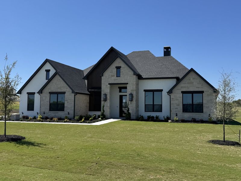Front exterior of a new home in Summit Ranch, Aledo, TX, highlighting curb appeal (Image 2). Front exterior of a new home in Summit Ranch, Aledo, TX, highlighting curb appeal (Image 2).