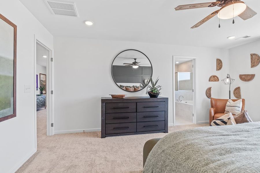 A bedroom with a large mirror.