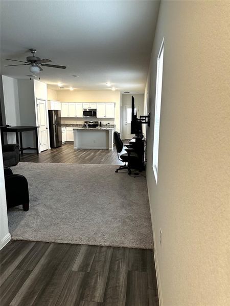 dark wood finished floors and a ceiling fan