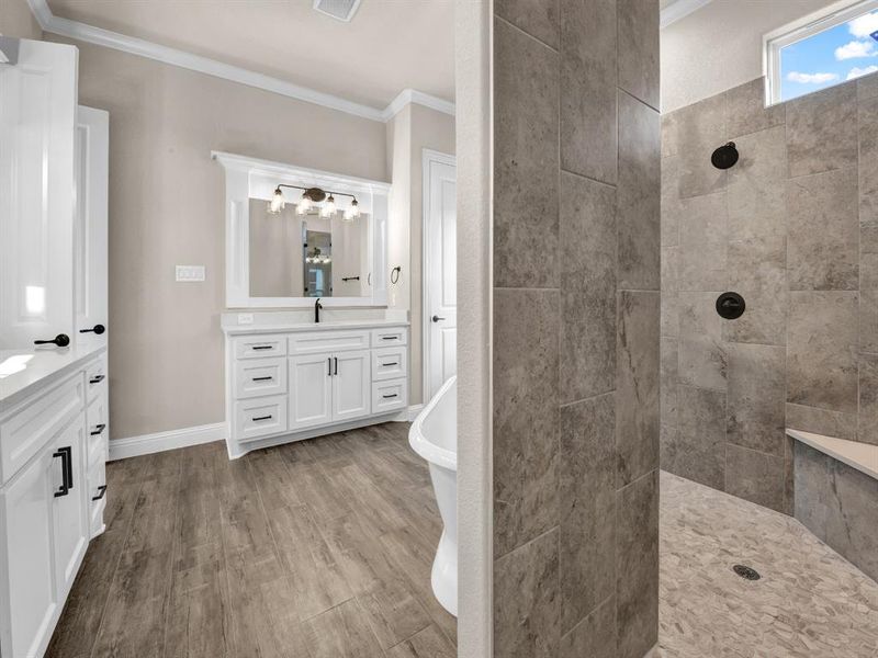 Bathroom with ornamental molding, vanity, and hardwood / wood-style floors