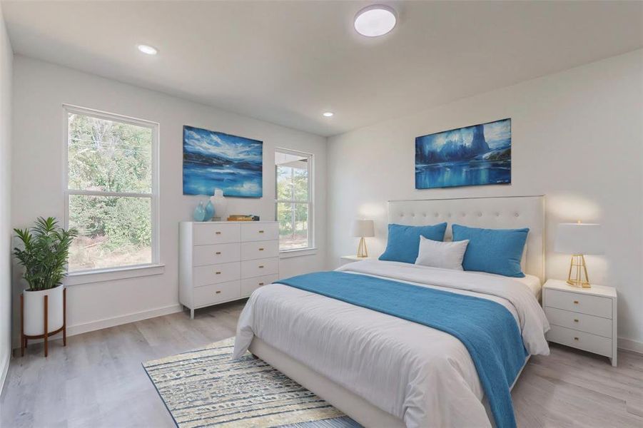 Bedroom with light hardwood / wood-style flooring and multiple windows