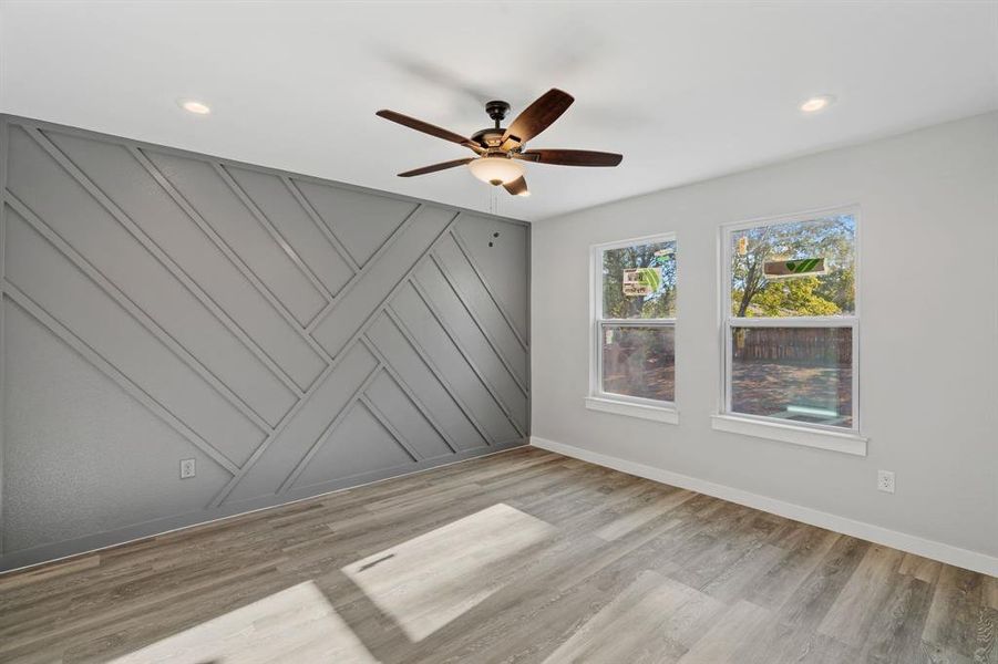 Unfurnished room with light hardwood / wood-style flooring and ceiling fan