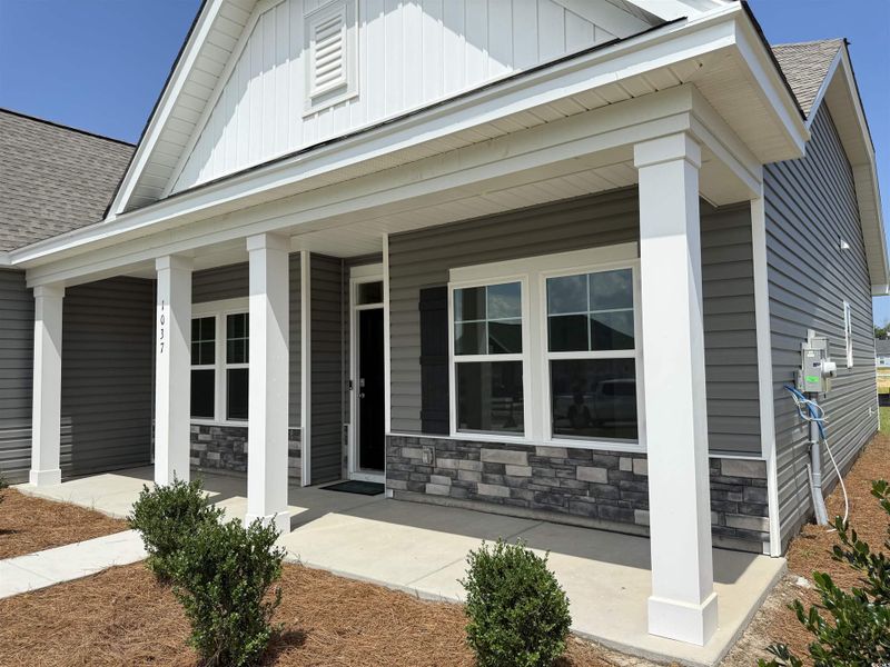 Front exterior of a new home in Avery Woods, Longs, SC, highlighting curb appeal (Image 2). Front exterior of a new home in Avery Woods, Longs, SC, highlighting curb appeal (Image 2).