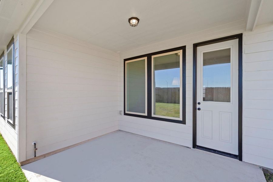 The covered patio is generously sized, providing ample space for various outdoor activities.