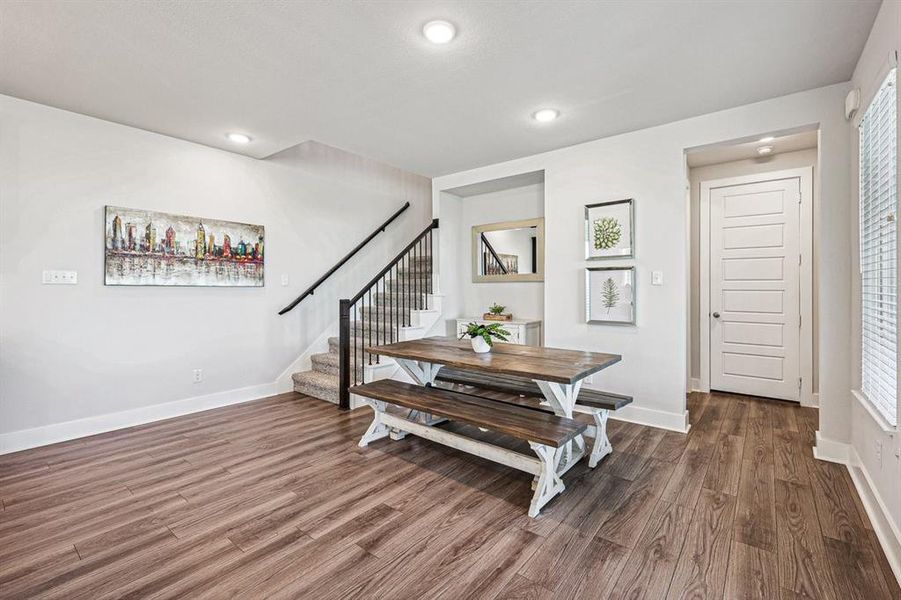 Open dining space perfect for entertaining and open stair railing