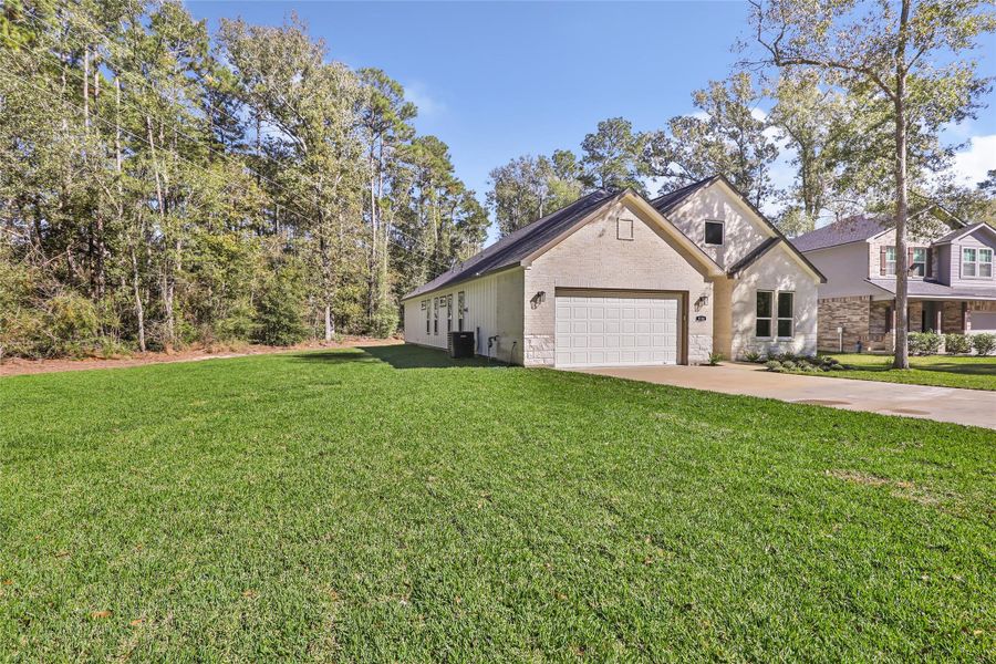 Front exterior of a new home in , New Caney, TX, highlighting curb appeal (Image 23).