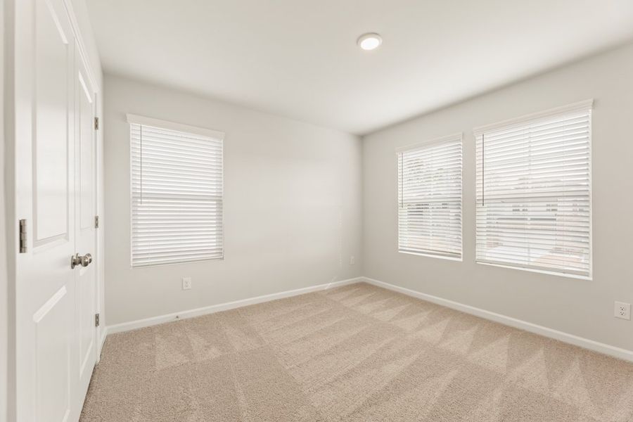 A room with white walls and a wood floor.