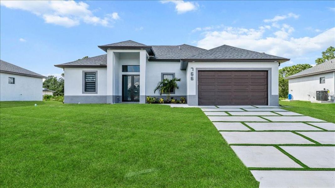 Front exterior of a new home in , Lehigh Acres, FL, highlighting curb appeal (Image 24).