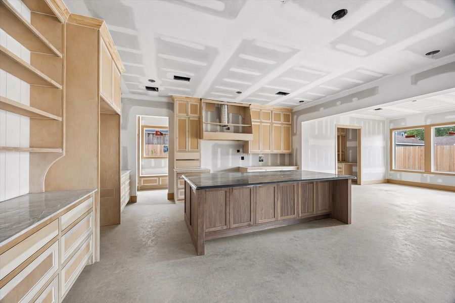 Open concept living anchored by a coffered ceiling detail and expansive wall space for custom cabinetry or statement finishes. Natural light pours in from the rear windows, creating seamless connection to the covered patio and backyard. Open concept living anchored by a coffered ceiling detail and expansive wall space for custom cabinetry or statement finishes. Natural light pours in from the rear windows, creating seamless connection to the covered patio and backyard.