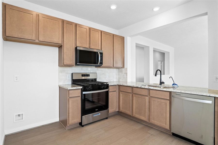 Additional view from kitchen showcasing the large open window looking into the Great Room-keeping everyone connected from the kitchen to the rest of the home. Additional view from kitchen showcasing the large open window looking into the Great Room-keeping everyone connected from the kitchen to the rest of the home.