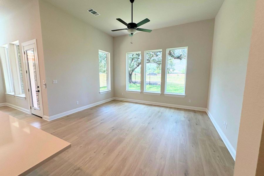A vast, naturally illuminated living area showcases soaring ceilings and durable wood flooring. A vast, naturally illuminated living area showcases soaring ceilings and durable wood flooring.