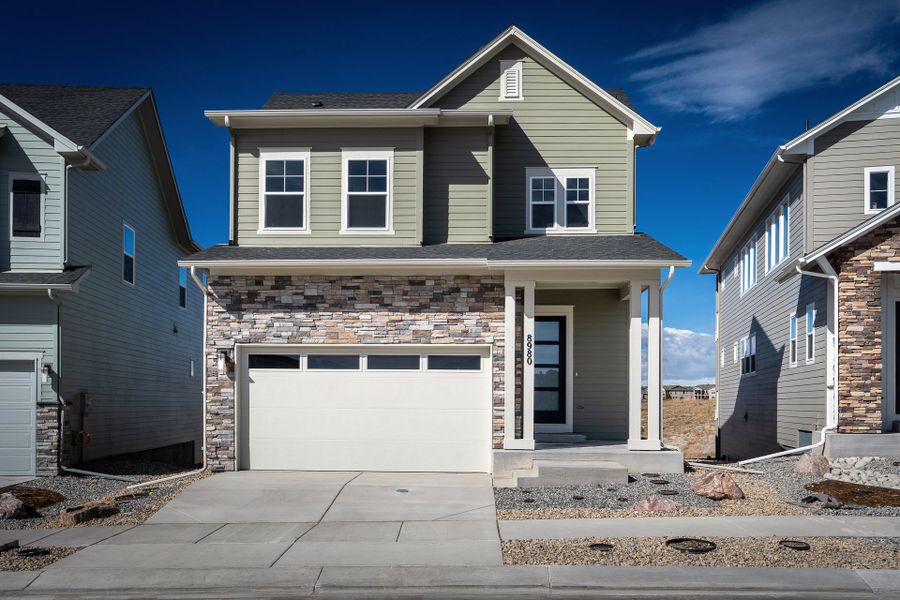 Front exterior of a new home in Revel Crossing at Wolf Ranch - The Panorama Collection, Colorado Springs, CO, highlighting curb appeal (Image 1). Front exterior of a new home in Revel Crossing at Wolf Ranch - The Panorama Collection, Colorado Springs, CO, highlighting curb appeal (Image 1).