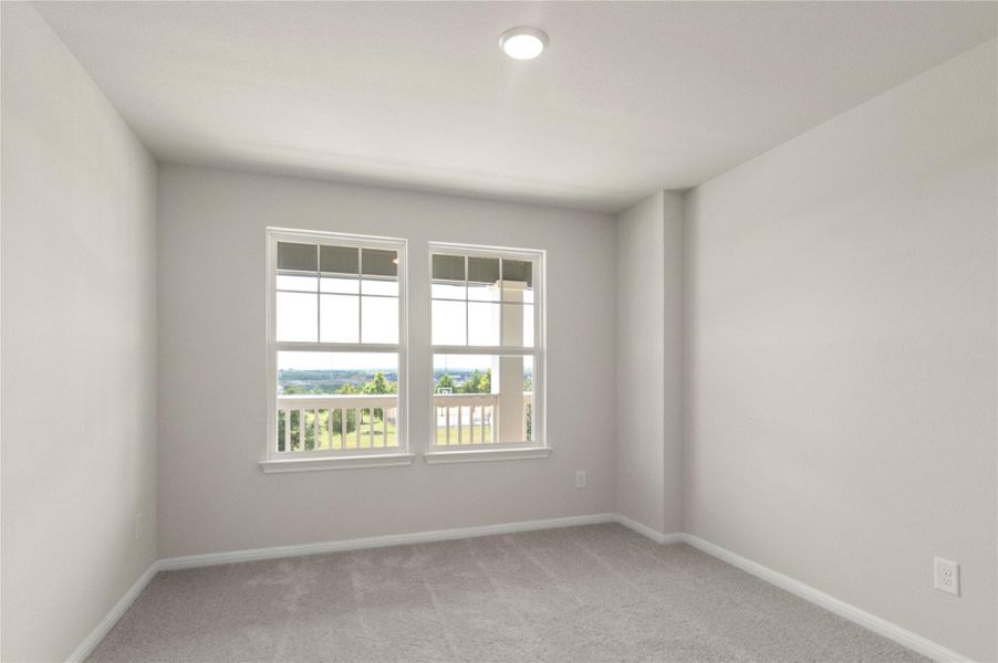 Spare room with light carpet and baseboards Spare room with light carpet and baseboards