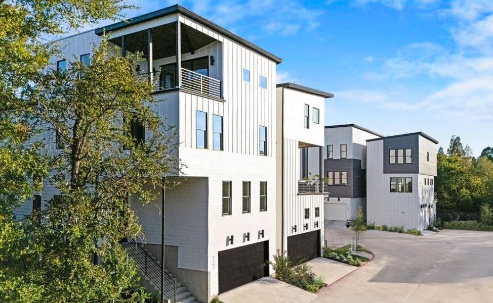 View of building exterior featuring a garage and concrete driveway View of building exterior featuring a garage and concrete driveway