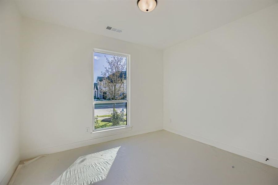 Unfurnished room with finished concrete floors and baseboards