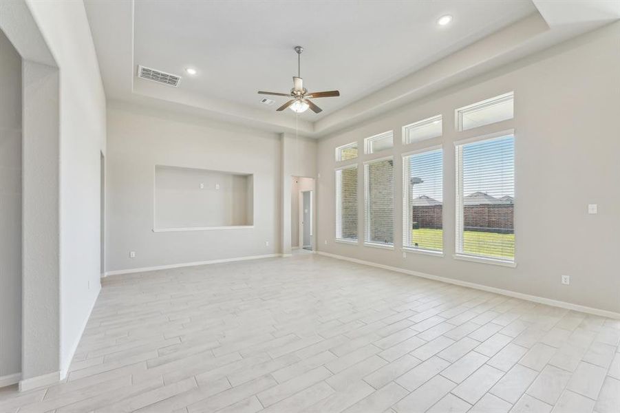 Step into a sun-drenched haven! This expansive living area boasts an abundance of natural light.