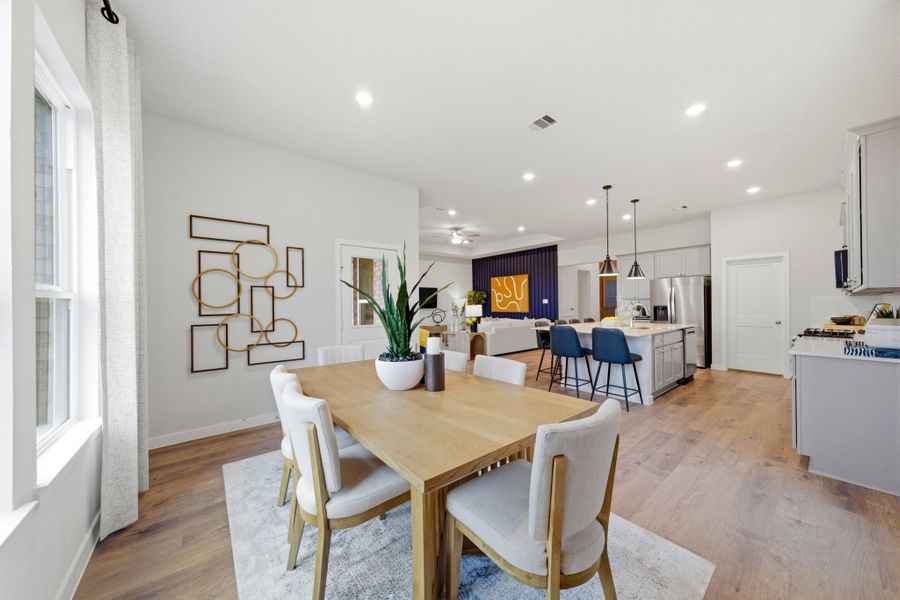 A dining room with a table and chairs. A dining room with a table and chairs.