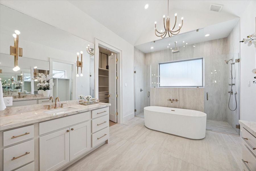 This stunning bathroom is enhanced by 17” vanity wall sconces that combine elegance with functionality.