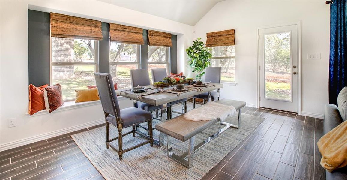 Dining room featuring vaulted ceiling and wood tiled floors Dining room featuring vaulted ceiling and wood tiled floors