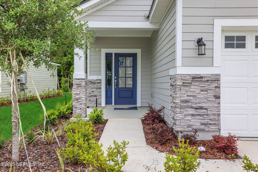 Front exterior of a new home in TrailMark, St. Augustine, FL, highlighting curb appeal (Image 25). Front exterior of a new home in TrailMark, St. Augustine, FL, highlighting curb appeal (Image 25).