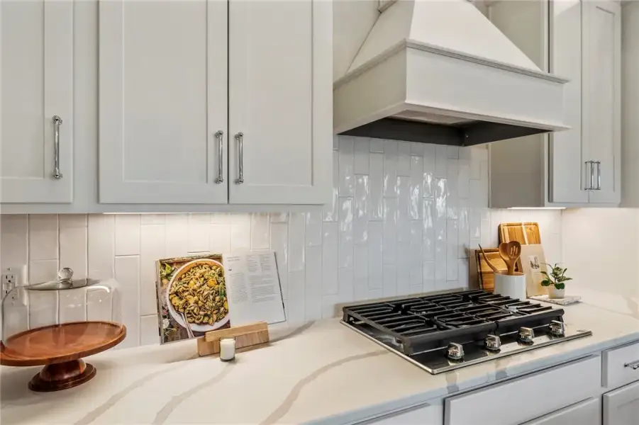 This sleek kitchen features a gas cooktop, modern