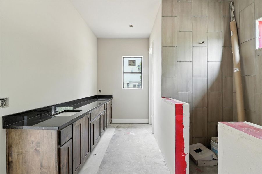 Bathroom with concrete flooring and double vanity Bathroom with concrete flooring and double vanity