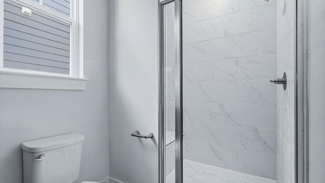 Notable primary bath featuring a walk-in shower and tasteful design touches throughout at the Barton Hollow community Notable primary bath featuring a walk-in shower and tasteful design touches throughout at the Barton Hollow community