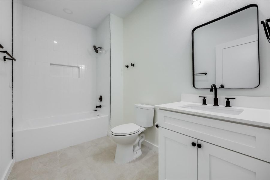 Bathroom featuring vanity, shower / bathtub combination, and tile patterned flooring Bathroom featuring vanity, shower / bathtub combination, and tile patterned flooring
