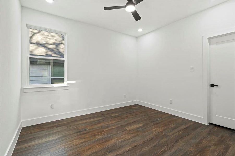 Spare room featuring dark wood finished floors, ceiling fan, and recessed lighting