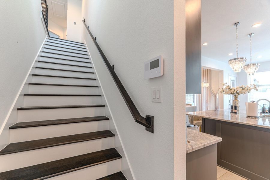 Staris Tucked In At Back of The Home Off Kitchen.