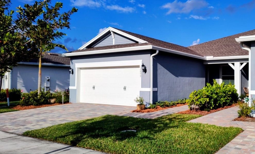 Front exterior of a new home in Del Webb Tradition, Port St. Lucie, FL, highlighting curb appeal (Image 17).