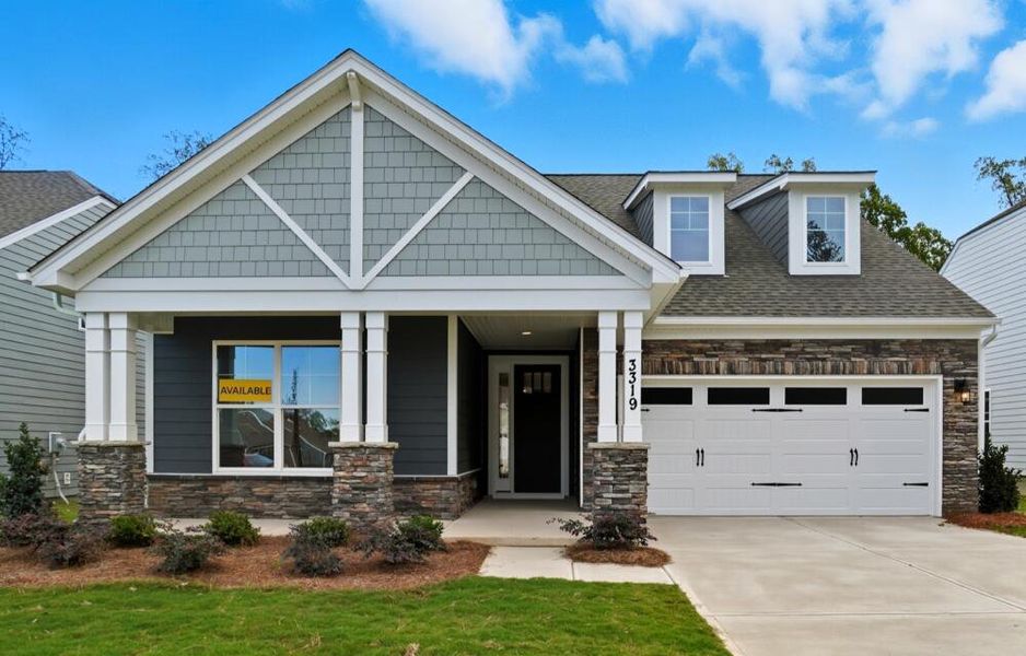 Front exterior of a new home in Heritage - 55+ Community, Wesley Chapel, NC, highlighting curb appeal (Image 1).
