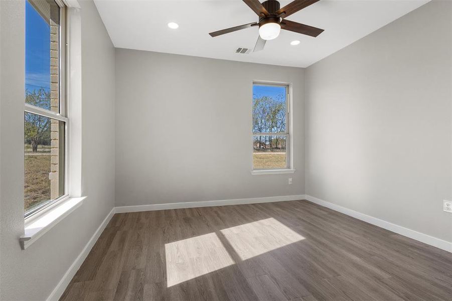 Spare room featuring wood finished floors, recessed lighting, and ceiling fan