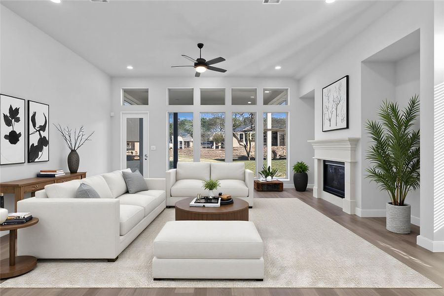 Bright and inviting living space featuring an open-concept design, soaring ceilings, and expansive windows that flood the room with natural light. Wide plank flooring and a seamless flow to the kitchen and dining areas create an ideal setting for both relaxed living and effortless entertaining. *Virtually Staged Bright and inviting living space featuring an open-concept design, soaring ceilings, and expansive windows that flood the room with natural light. Wide plank flooring and a seamless flow to the kitchen and dining areas create an ideal setting for both relaxed living and effortless entertaining. *Virtually Staged