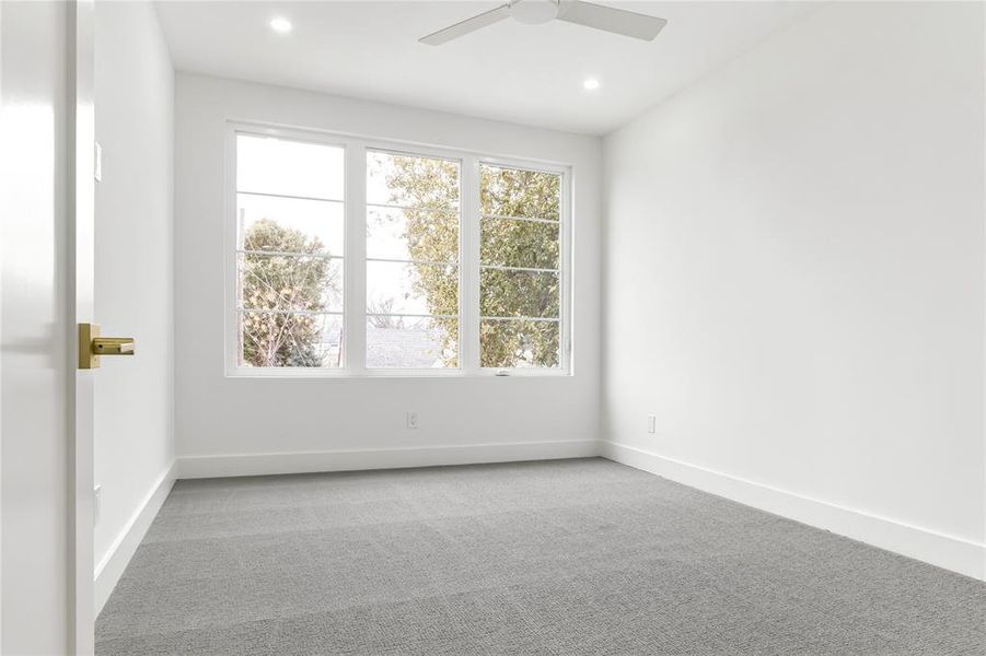 Spare room with ceiling fan and light carpet